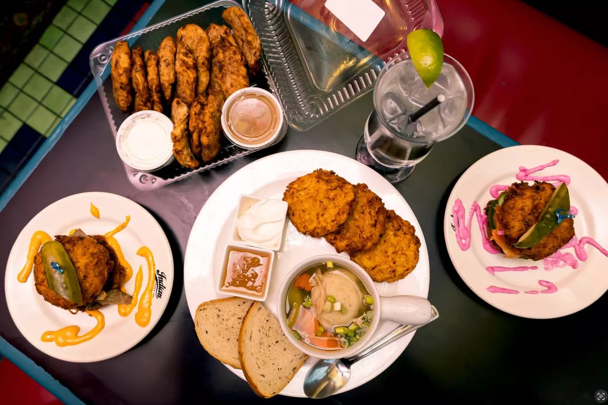 Potato latkes, fritters and a bowl of soup on plates at Free Times Cafe, seen from above