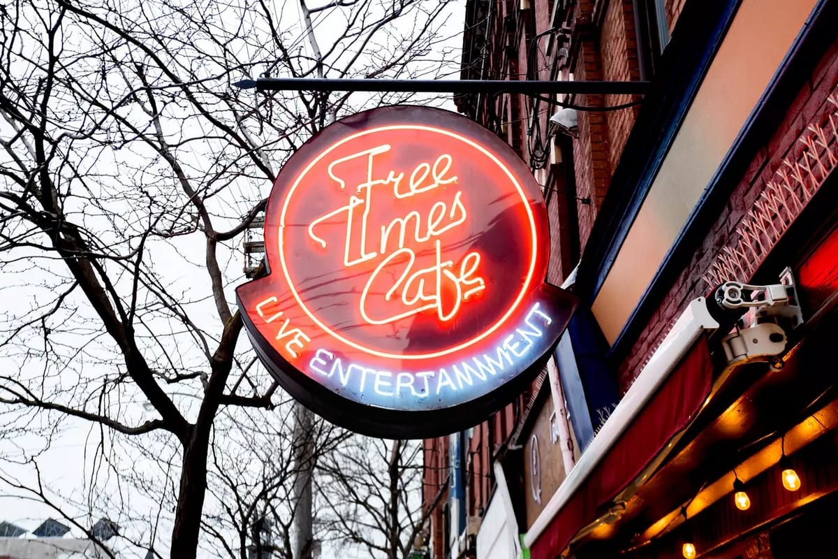 The round red neon Free Times Cafe sign reading Live Entertainment, outside on College Street